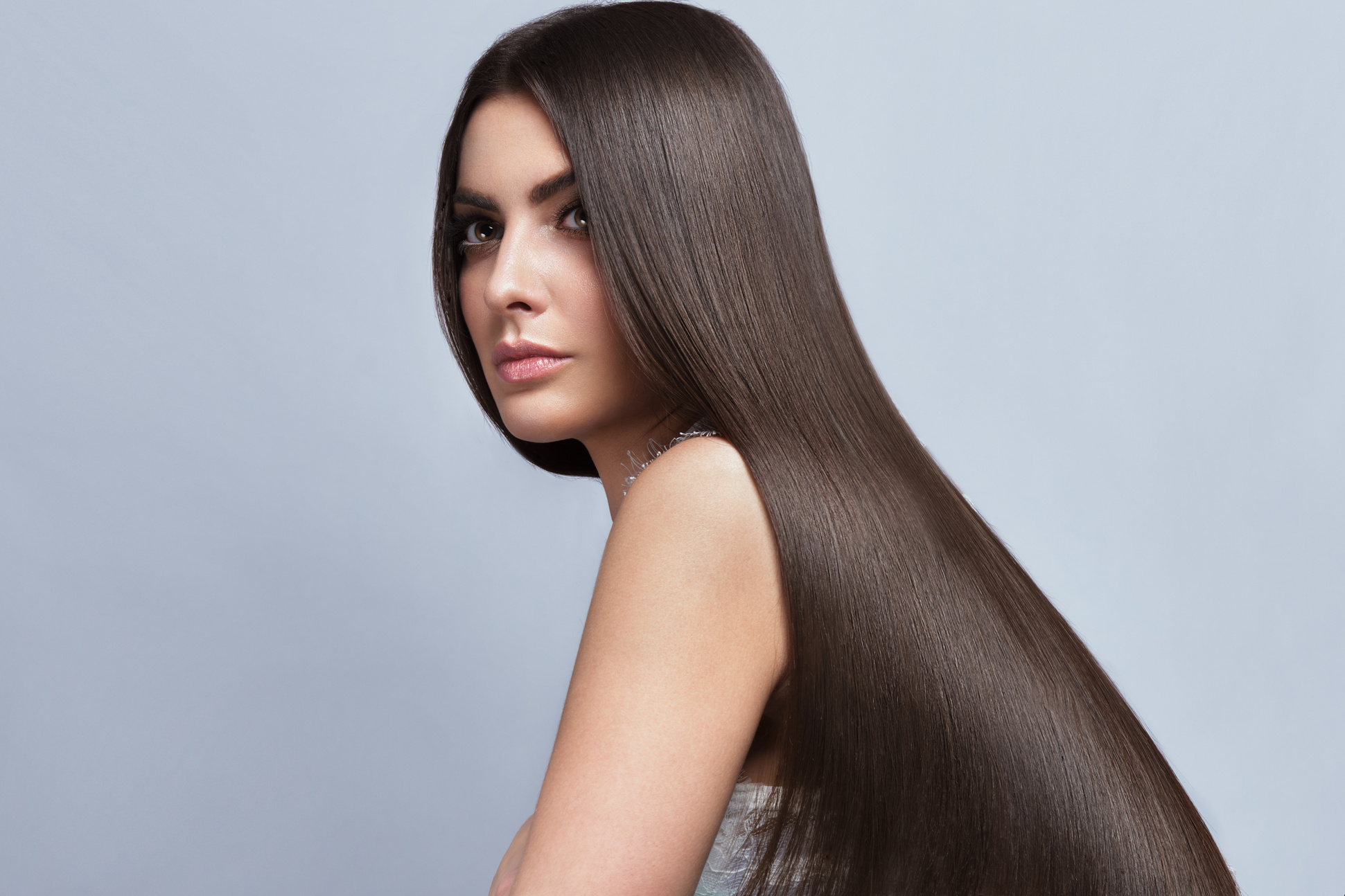 Beautiful brown-haired girl with a perfectly smooth hair, an